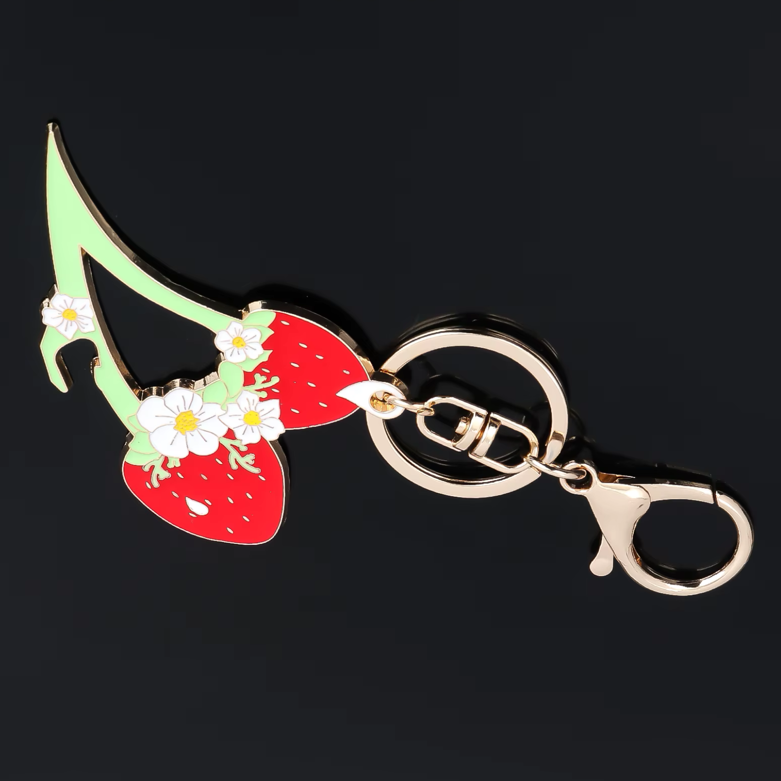 Keychain with high-heeled shoe and strawberry design on a black background