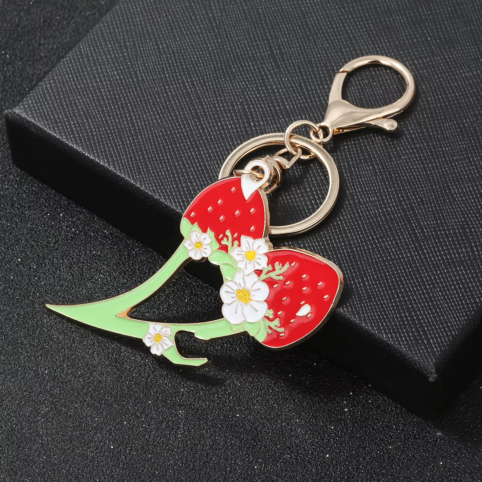Keychain with strawberry design on a black background