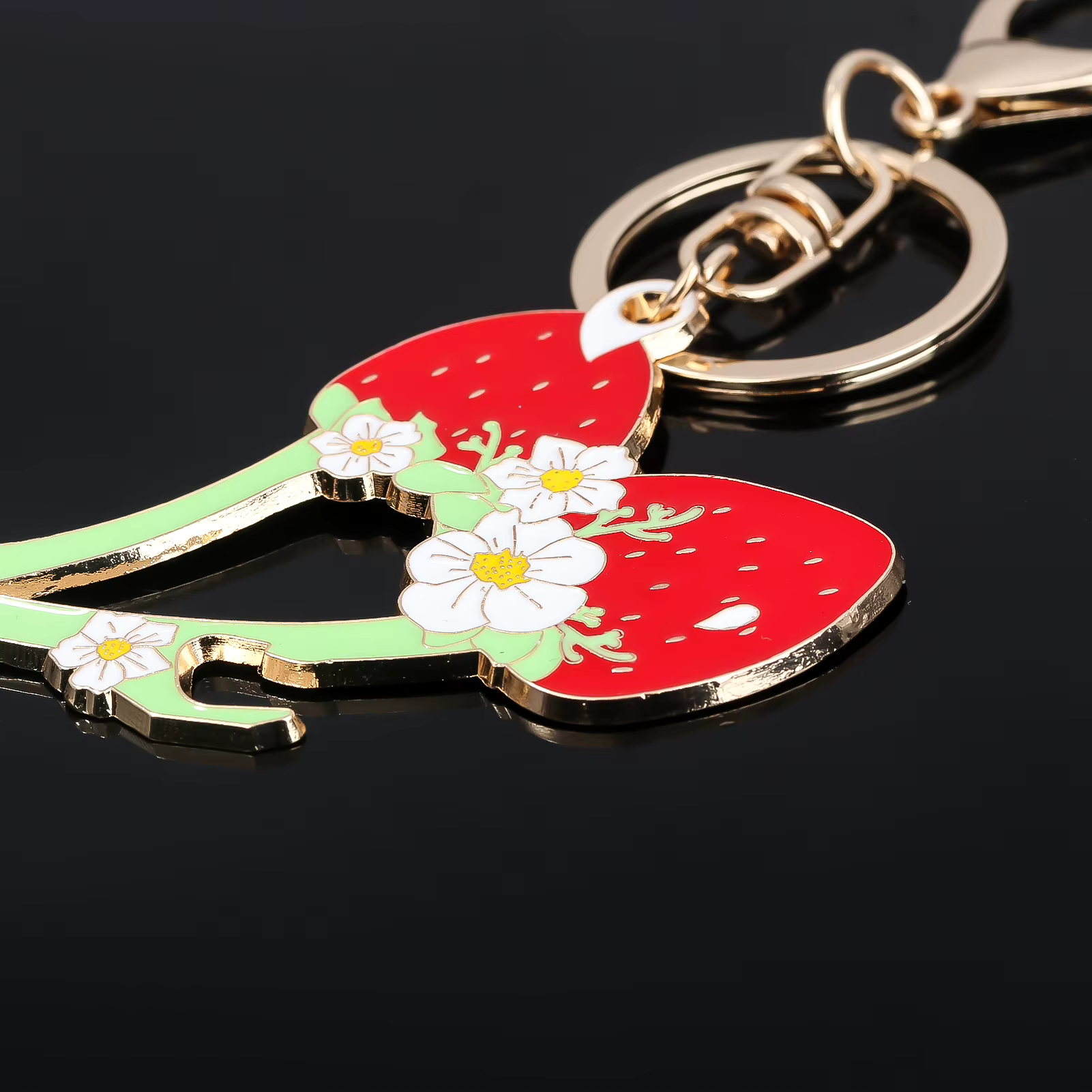 Keychain with a design of a green lizard on a red background with white flowers, on a black background.