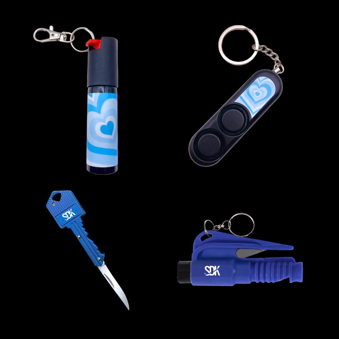 Blue heart self-defense keychain kit with pepper spray, alarm, knife, and window breaker arranged together